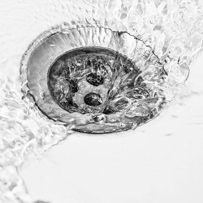 Water flowing into metal drain